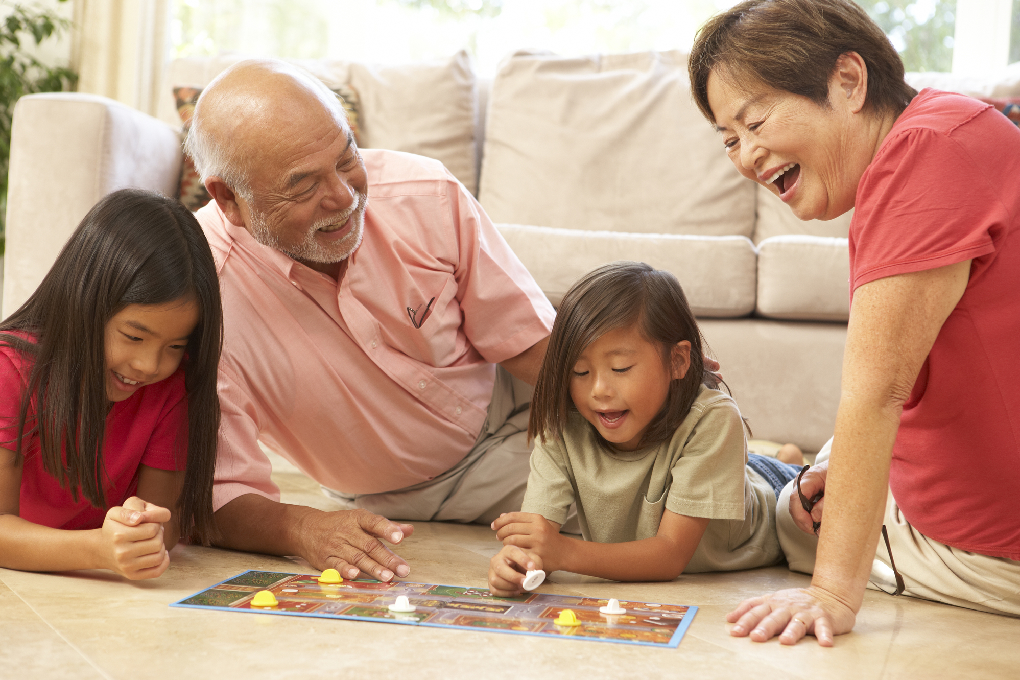 Grandparents and grandchildren at home playing a game